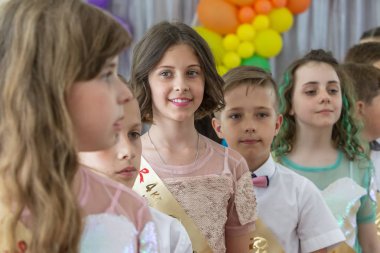Odessa, Ukrayna - 31,2018 olabilir: Çocuk müzikal grup şarkı ve sahne alanı'nda İlköğretim Okulu mezuniyet konser sırasında dans. Çocuk oyun. Duygusal çocuk göstermek sahnede. Çocukların yaratıcılık
