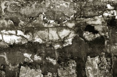 Alçı tuğla duvarın boş eski sanat dokusu. Yaprak dokusuyla boyanmış taş tuğla duvarın çatlaklarıyla kötü çizilmiş yüzey. Hasarlı alçıyla binanın ön cephesini ovaladım.
