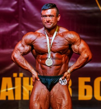 Odessa, Ukrayna -23 Ekim 2016: sporcular erkekler vücut geliştirme ve fitness kategori fitness ve vücut geliştirme modeli üzerinde Şampiyonası Ukrayna katılmak. Sahne Alanı'nda büyük kas erkeklerle güzel atletik rakam