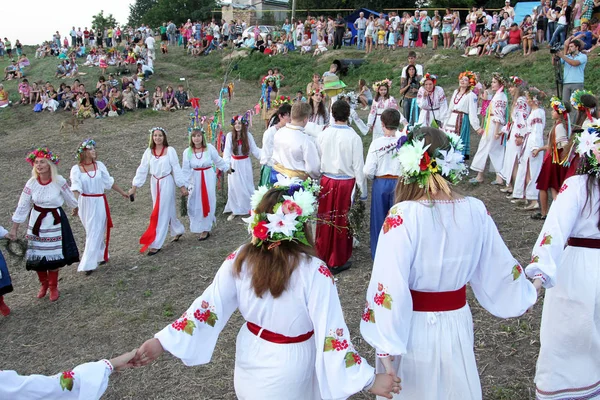 ODESSA, UKRAINE - August 24, 2014: Ukrainian people celebrating girl National Day holiday Midsummer on the river in bright robes embroidered Ukrainian cross