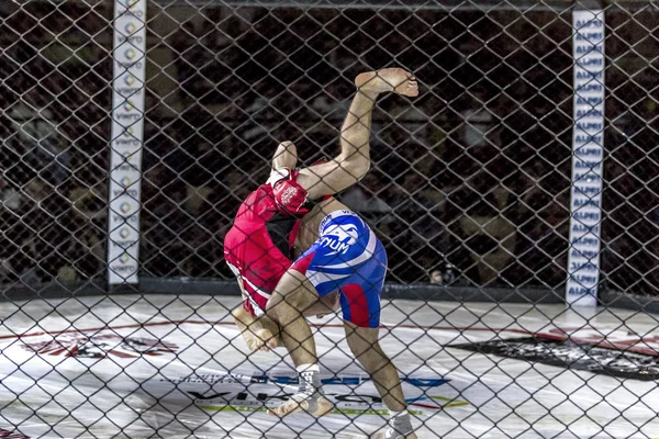 Odessa, Ukrayna - 13 Aralık: Atletizm Mma, karışık dövüş sanatları savaşçı hücrede rekabet neden yumruk atıyor ve başladı. Dramatik an savaş, 13 Aralık 2014 Odessa, Ukrayna