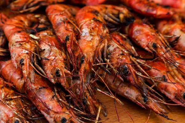 Creative background for menu advertising: Roasted red royal large shrimp. Seafood fried in appetizer menu at beer menu map. Fried shrimp on platter. Selective focus