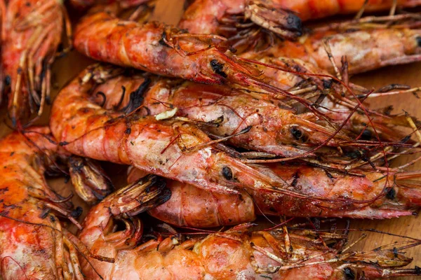 Creative background for menu advertising: Roasted red royal large shrimp. Seafood fried in appetizer menu at beer menu map. Fried shrimp on platter. Selective focus
