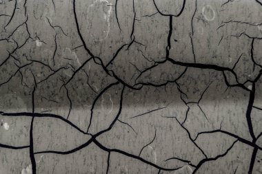 Arka plan eski boya kırık. Yüzeyi büyük çatlaklar. Katmanları kapatın; birçok boya ve kağıt katmanları soyut bir doku vermek; arka plan makro peeling boyalı yüzey oluşturur