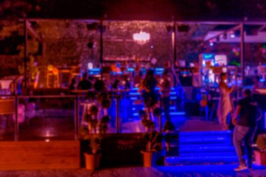 Küçük bir restoranın içi bulanık bir arka plan. Bokeh Kafe 'nin içini sıcak koyu renklerle bulanıklaştırmış. Yaratıcı moda tasarımı için arka plan olarak. Restoran, kafeterya arka planı çok güzel bulanık.