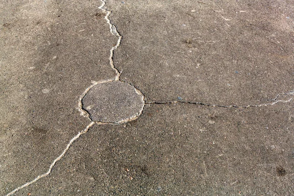 Very bad paved road. Cracks in the pavement, potholes. Very poor condition of local asphalt road after a low-quality patching