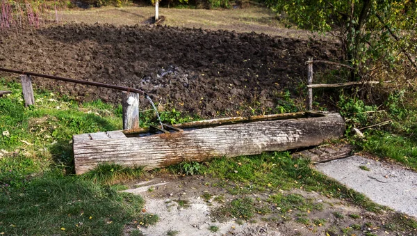 Traditional wooden trough - troughs for animals and humans, the concentration of pure water from mountain springs. Ancient peasant household technology