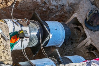 Odessa, Ukrayna - 29 Eylül 2016: Temelli onarım ve değiştirme büyük kentsel ısı boru. Eski paslı değiştirme ve sızan su boruları. Ortak belediye hizmetlerinin mühendislik yeni teknolojiler