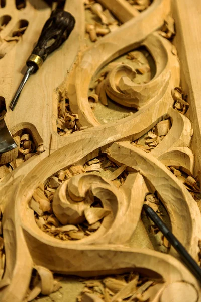 Woodworking. Joinery works. Woodcarving. Workplace of woodcarver, tools on a wooden background close-up. Use as background folk crafts. Wood carving