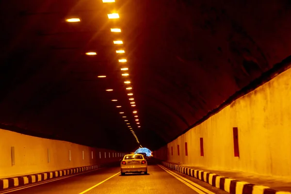 Abstract Motion Blur Background road tunnel with moving cars and light at the end. For use as a creative design blank. Light line of traffic in the tunnel lighting car highway