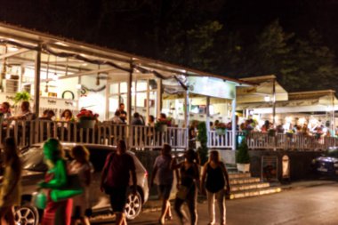 Küçük bir restoranın içi bulanık bir arka plan. Bokeh Kafe 'nin içini sıcak koyu renklerle bulanıklaştırmış. Yaratıcı moda tasarımı için arka plan olarak. Restoran, kafeterya arka planı çok güzel bulanık.