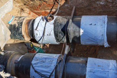 Odessa, Ukrayna - 29 Eylül 2016: Temelli onarım ve değiştirme büyük kentsel ısı boru. Eski paslı değiştirme ve sızan su boruları. Ortak belediye hizmetlerinin mühendislik yeni teknolojiler
