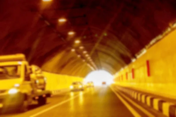 Abstract Motion Blur Background road tunnel with moving cars and light at the end. For use as a creative design blank. Light line of traffic in the tunnel lighting car highway