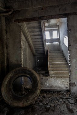 Interior of an abandoned administrative building. Interior ruins of an industrial factory. An old concrete staircase, ruins, corridor with garbage and mud, ruined walls of an unfinished office business center, Odessa clipart
