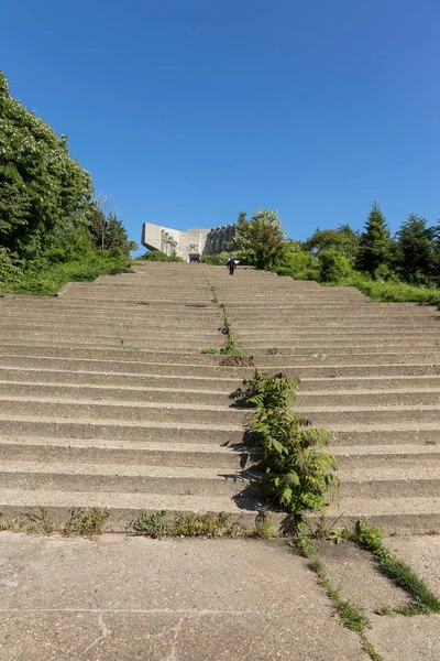 An old outdoor outdoor stone staircase. Stone, cement steps of old staircase with traces of weathering and destruction. Vintage stone staircase, ancient broken steps. Selective focus