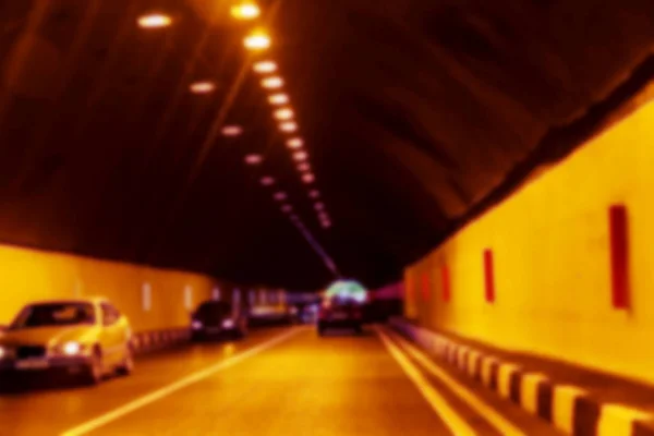Abstract Motion Blur Background road tunnel with moving cars and light at the end. For use as a creative design blank. Light line of traffic in the tunnel lighting car highway