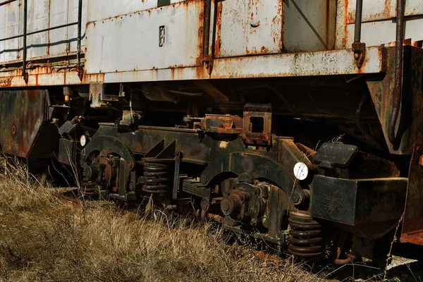 Old rusty train locomotive thrown into exclusion zone of Chernobyl. Zone of high radioactivity. Ghost town of Pripyat. Chernobyl disaster. Rusty abandoned Soviet machinery in area of nuclear accident at plant