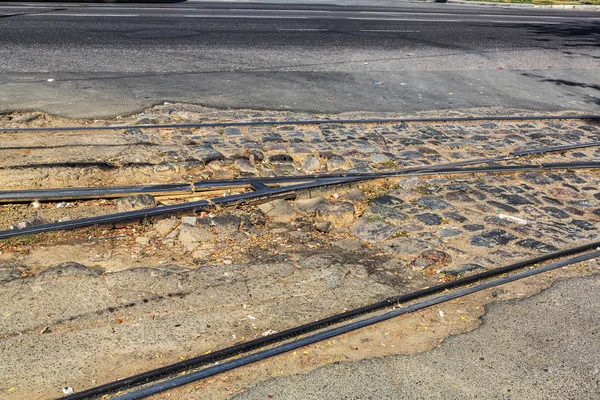 Very bad paved road. Cracks in the pavement, potholes. Very poor condition of local asphalt road after a low-quality patching