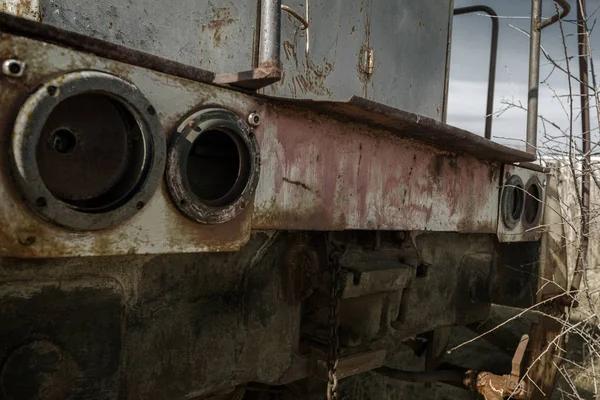 Old rusty train locomotive thrown into exclusion zone of Chernobyl. Zone of high radioactivity. Ghost town of Pripyat. Chernobyl disaster. Rusty abandoned Soviet machinery in area of nuclear accident at plant