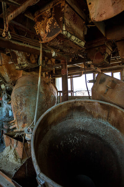Old abandoned industrial building of cement plant Chernobyl. Ruins of an old factory. Rubbish, rusty metal is broken equipment of cement plant. Element for apocalyptic design, retro, stalker