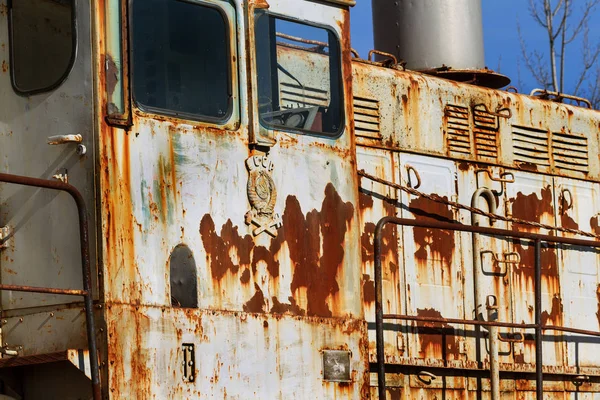 Old rusty train locomotive thrown into exclusion zone of Chernobyl. Zone of high radioactivity. Ghost town of Pripyat. Chernobyl disaster. Rusty abandoned Soviet machinery in area of nuclear accident at plant