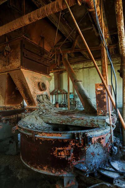 Old abandoned industrial building of cement plant Chernobyl. Ruins of an old factory. Rubbish, rusty metal is broken equipment of cement plant. Element for apocalyptic design, retro, stalker