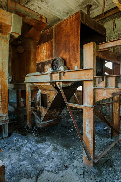 Old abandoned industrial building of cement plant Chernobyl. Ruins of an old factory. Rubbish, rusty metal is broken equipment of cement plant. Element for apocalyptic design, retro, stalker