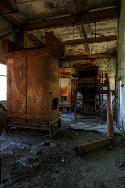 Old abandoned industrial building of cement plant Chernobyl. Ruins of an old factory. Rubbish, rusty metal is broken equipment of cement plant. Element for apocalyptic design, retro, stalker