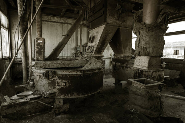 Old abandoned industrial building of cement plant Chernobyl. Ruins of an old factory. Rubbish, rusty metal is broken equipment of cement plant. Element for apocalyptic design, retro, stalker
