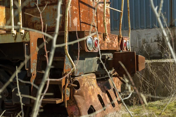 Old rusty train locomotive thrown into exclusion zone of Chernobyl. Zone of high radioactivity. Ghost town of Pripyat. Chernobyl disaster. Rusty abandoned Soviet machinery in area of nuclear accident at plant