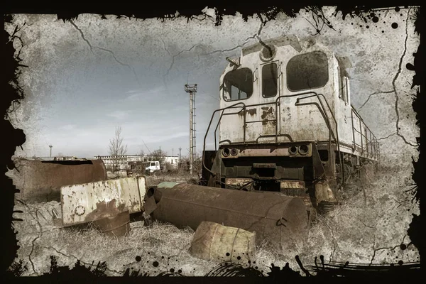 Old rusty train locomotive thrown into exclusion zone of Chernobyl. Zone of high radioactivity. Ghost town of Pripyat. Chernobyl disaster. Rusty abandoned Soviet machinery in area of nuclear accident at plant