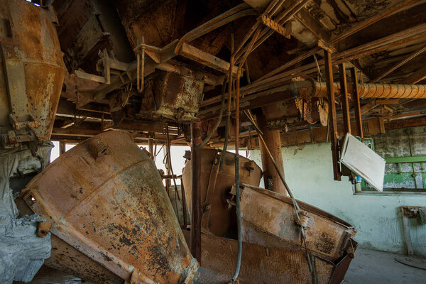Old abandoned industrial building of cement plant Chernobyl. Ruins of an old factory. Rubbish, rusty metal is broken equipment of cement plant. Element for apocalyptic design, retro, stalker