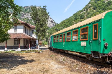 Bansko, Bulgaristan -29 Temmuz 2016: küçük retro rock Tren Garı yolcu sırt boyunca geçmiş dağ yolu virajlı yıpranmış eski dar hat raylar üzerinden taşır