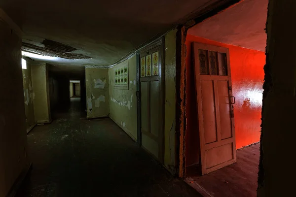 Dark corridor. Mystical interior of dark empty corridor, tunnel in an abandoned house. Dark mysterious corridor. The interior of an abandoned house, road to hell. An old abandoned building