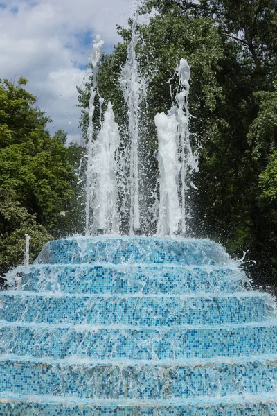 城市喷泉在炎热的夏天 在城市公园的喷泉 在美丽的城市喷泉中 水滴和明亮的水花 白天城市喷泉中明亮的波光粼粼的水流 — 图库照片