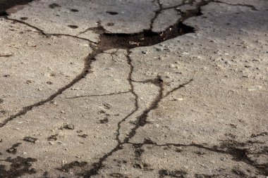 Çukurlar, kışın donma-çözülme çevrimleri neden olan bozuk asfalt yol. Kötü yol. Kaldırımlar kaldırımlar kaldırımda kırık. kaldırım döşeme ile kusurları ile tabaka ve perspektif içinde gelen çatlaklar