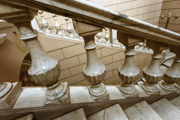 An old open stone staircase. Stone, marble steps of old staircase with traces of  destruction. An ancient marble staircase, ancient broken worn steps. old majestic, grandiose, marble stone staircase