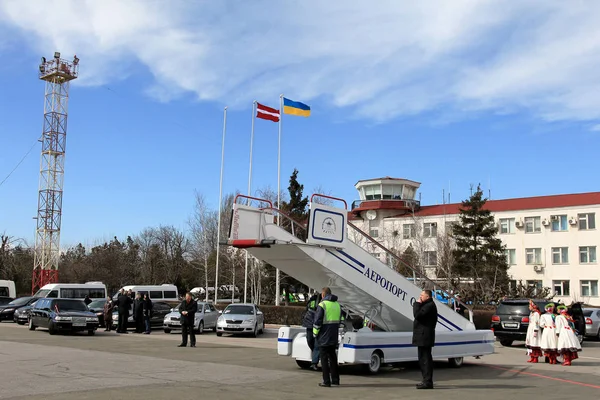 ODESSA, UKRAINE - June 6, 2014: official visit to Ukraine, Odessa President of Latvia Andris Berzins. Solemn meeting at the airport. The plane of the President. Attributes of Latvia - Latvian flag