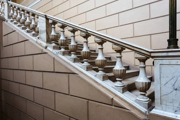 An old open stone staircase. Stone, marble steps of old staircase with traces of  destruction. An ancient marble staircase, ancient broken worn steps. old majestic, grandiose, marble stone staircase