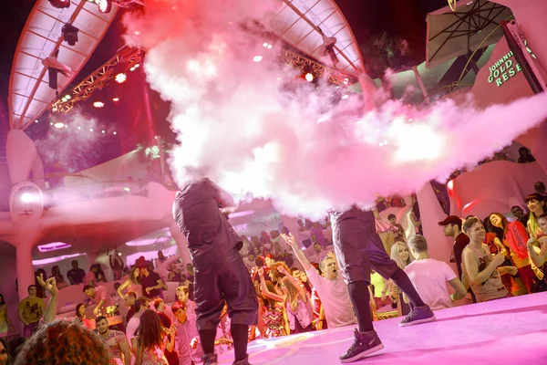 オデッサ ウクライナ 2014 創造的な光と音楽のショーの実行中 ナイトクラブ コンサートで楽しい人の大観衆 紙吹雪と素晴らしいステージ クラブ パーティーで煙を浴びせ陽気な若者 — ストック写真