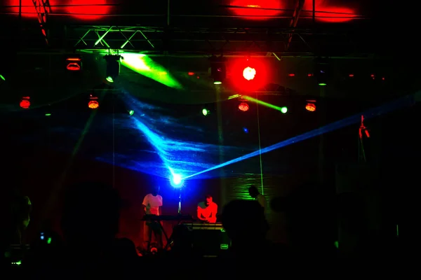 Lights show. Laser show. Nightclub dj parties use music, dancing sound with bright light. club night light dj party club. With car for smoke and lights. Creative Light show on open nightclub scene