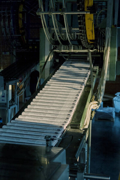Working process of printing circulation of news newspaper. Tape of conveyor with newspaper running in process. Work of modern printing equipment when printing printed products