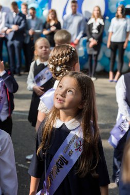 Odessa, Ukrayna 1 Eylül 2017: Okul bahçesinde öğrenciler ve öğretmenler ile okul çizgi var. Çocuklar okula geri dön. Bilgi gün, okulun ilk günü. Birinci sınıf öğrencileri sınıfta oturmak