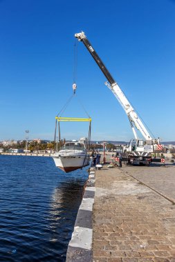 Varna, Bulgaristan - 21 Kasım 2015: özel yat bir iskele marina deniz bağlantı noktası Varna gelen suyu denize indirmek. Seaport Vinçler, profesyonel eser.