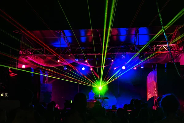 Lights show. Laser show. Night club dj party people enjoy of music dancing sound with colorful light. Club night light dj party club. With Smoke Machine and lights. Bright Performance laser Light show