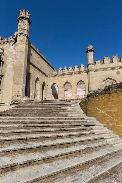 An old outdoor outdoor stone staircase. Stone, cement steps of old staircase with traces of weathering and destruction. Vintage stone staircase, ancient broken steps. Selective focu