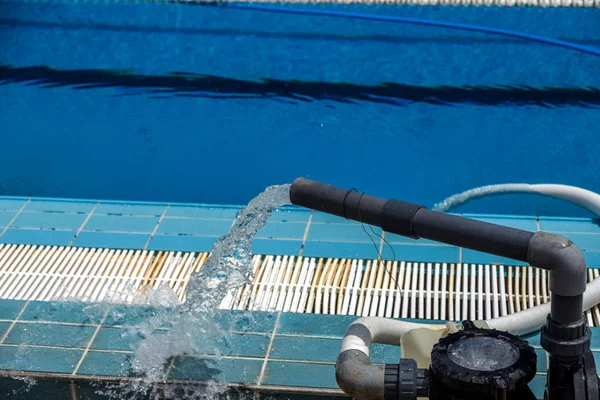 Cleaning the sports pool with a cleaning water pump. The water pump filters the water from the bottom of the pool, cleans from dirt and debris. The cleaning pump works with the pool.