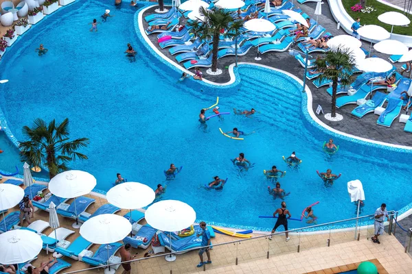 ODESSA, UKRAINE - JULY 20: Tourists on holiday in an expensive hotel Nemo popular with cascading pools and with dolphins and white whales, and dzhakusi bar, water aerobics July 20, 2014 Odessa, Ukraine.