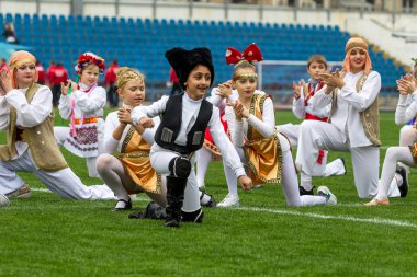 Odessa, Ukrayna - 21 Ekim 2017: Sahne alanı'nda çocuk. Genç çocuk topluluğu Stadyumu yeşil çimenlerin üzerinde Ulusal kostüm dans dans. Stadyumda dans çocuk