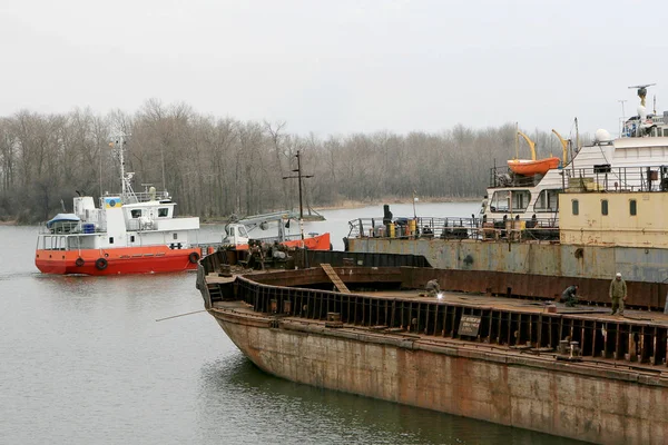 ODESSA - April 15, 2014: Old river trading port Ust -Danube . Human outdated repair river vessels , barges at the shipyard docks. Ancient Technology , April 15, 2014 Odessa, Ukraine